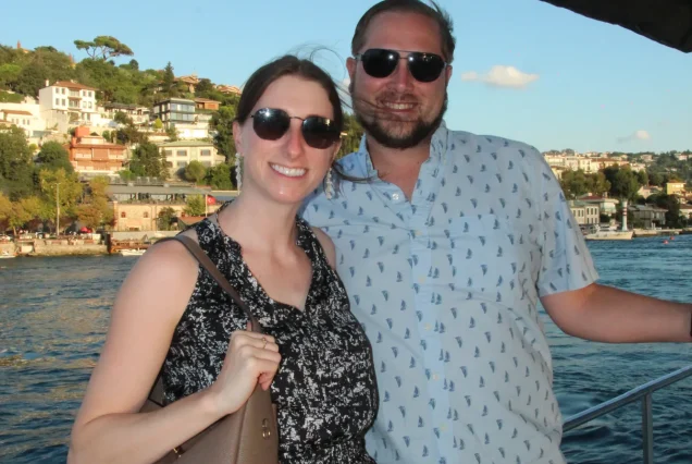 Couple on the Bosphorus cruise with a hillside view
