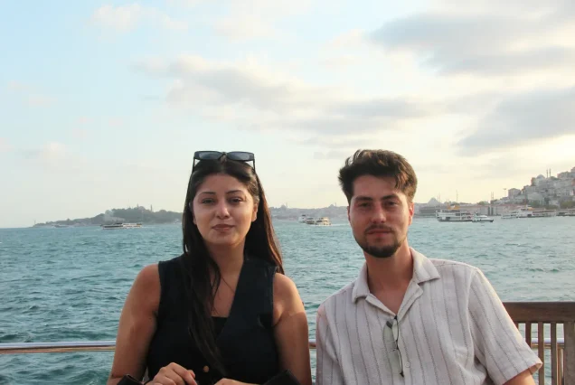 Young couple on the Bosphorus cruise with city view