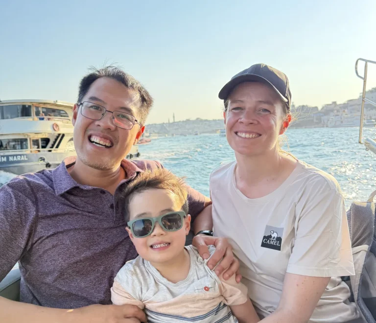 Family on a private Bosphorus boat tour in the daytime passing Ortaköy Mosque in Istanbul