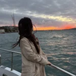 Bosphorus cruise sailing through autumn rain at dusk